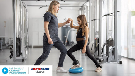 A woman and child trying to balance in the gym