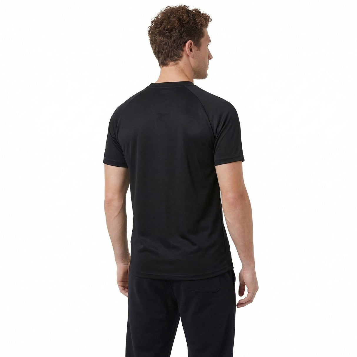 Man wearing a black t-shirt and pants on a white background