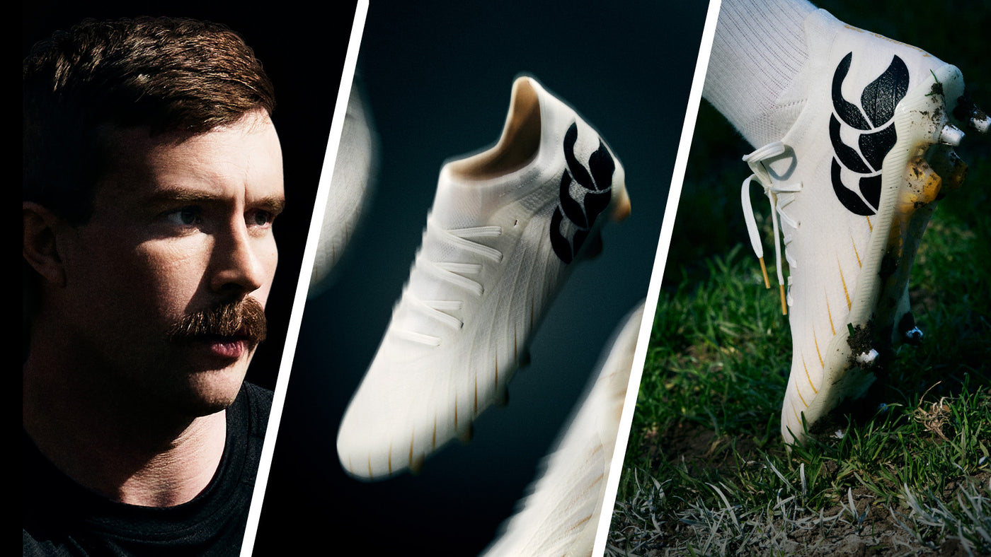 An image of Mack Hansen looking towards the new Canterbury white Rugby boots sitting in the grass with the heel up