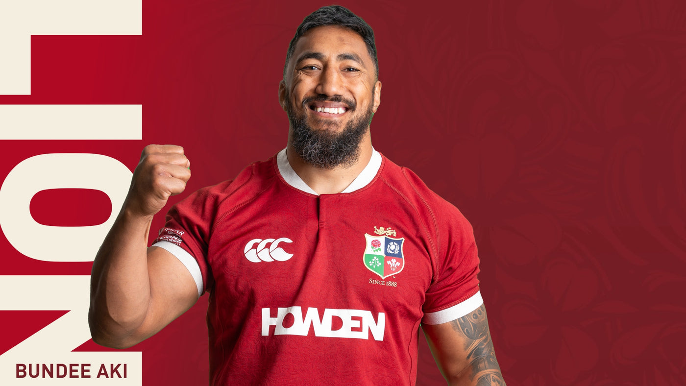 An image of Bundee Aki holding his arm in the air whilst wearing the 2025 British Irish Lions Jersey