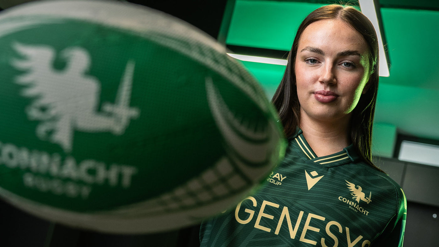 An image of a Connacht Rugby player wearing the 2025/26 Home Team Jersey while holding out a blurred Connacht Rugby Ball