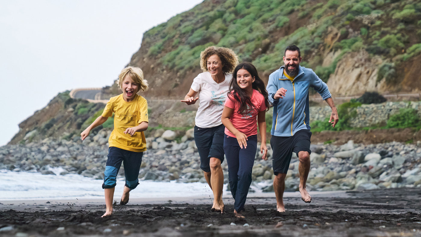 A family running on the beach