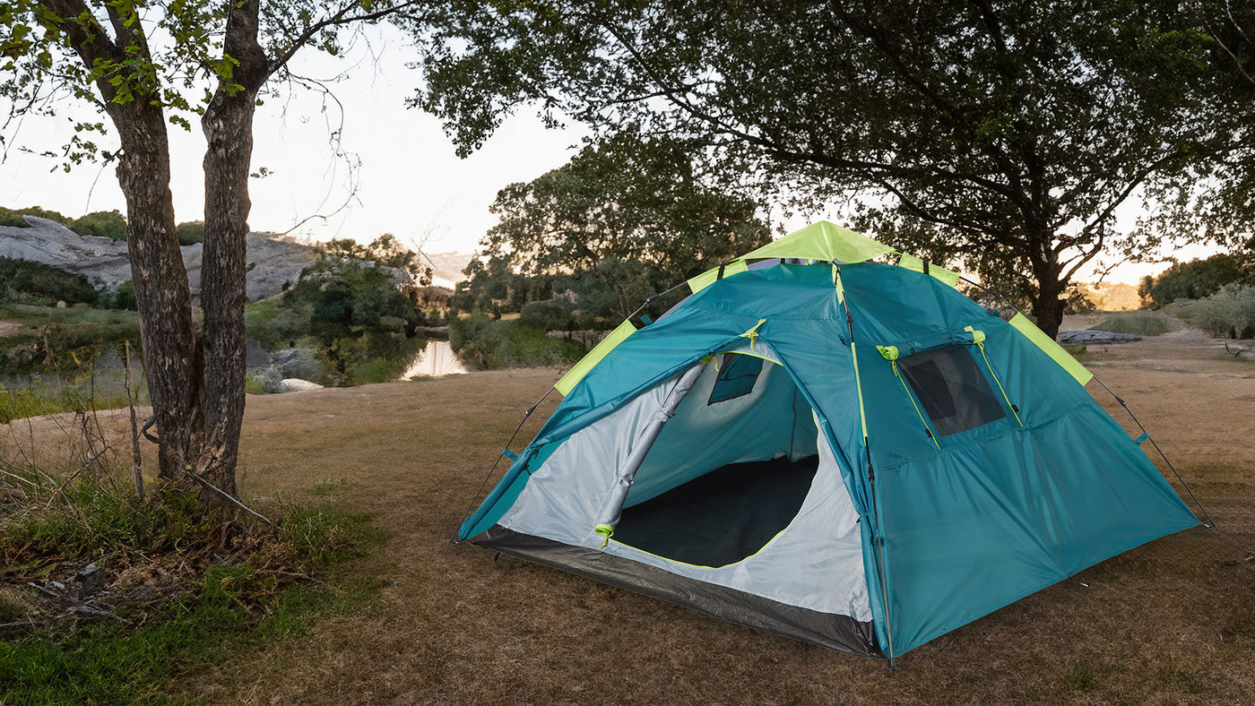 A McKinely tent setup beside a lake