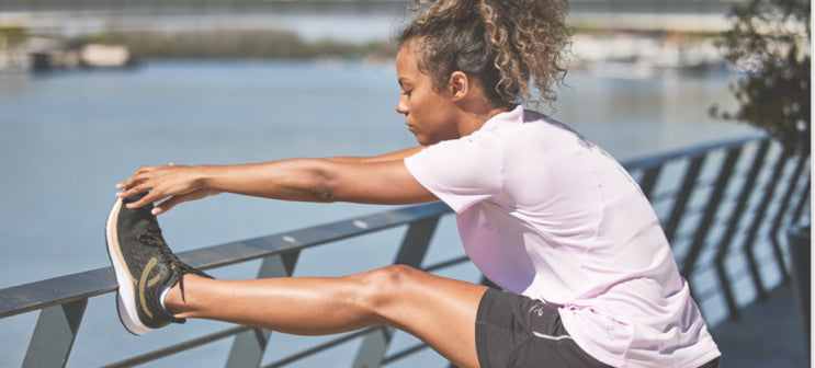 A woman stretching before a run