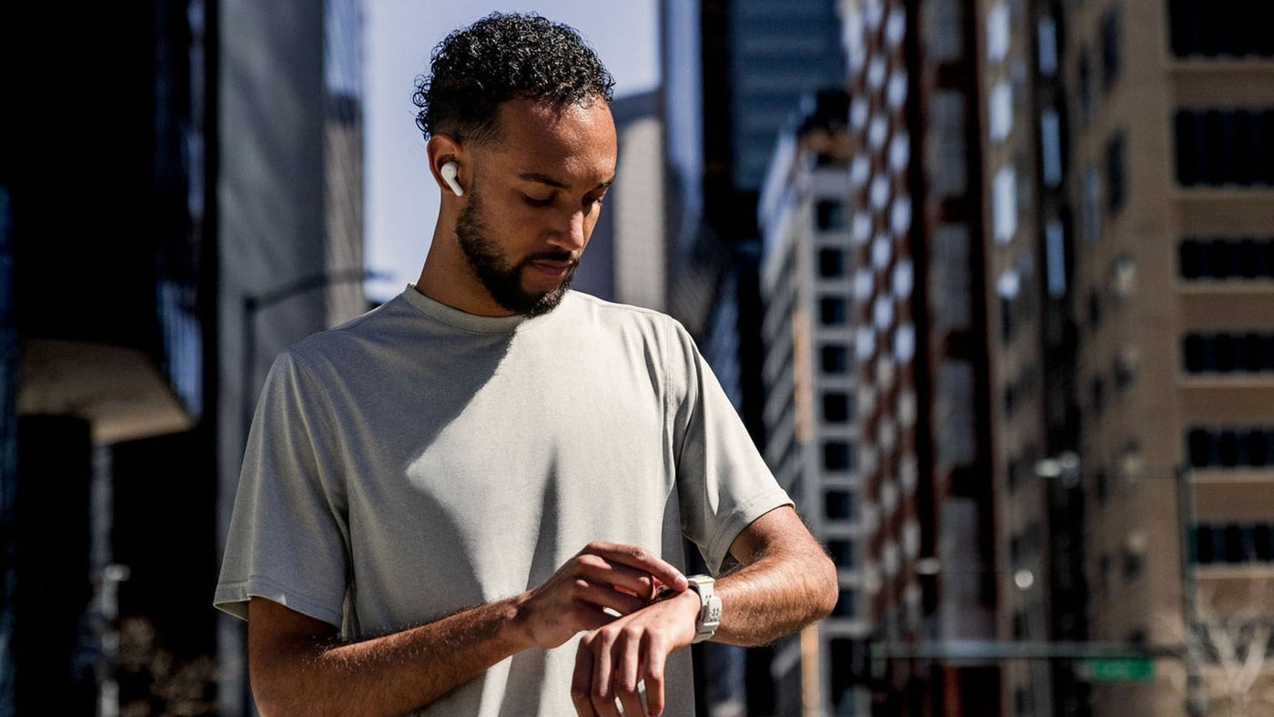 A male checking his smartwatch whilst out running