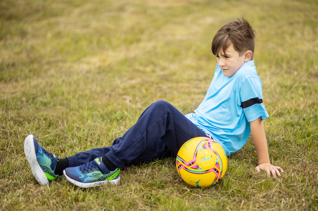 Young kid stretches before completing a kid friendly workout