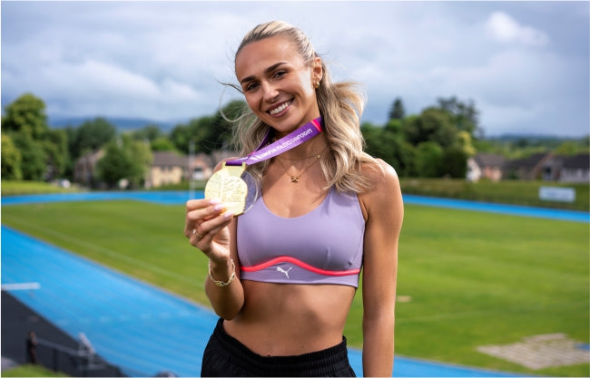 Sharlene Mawdsley holding her European Athletics medal in her hand