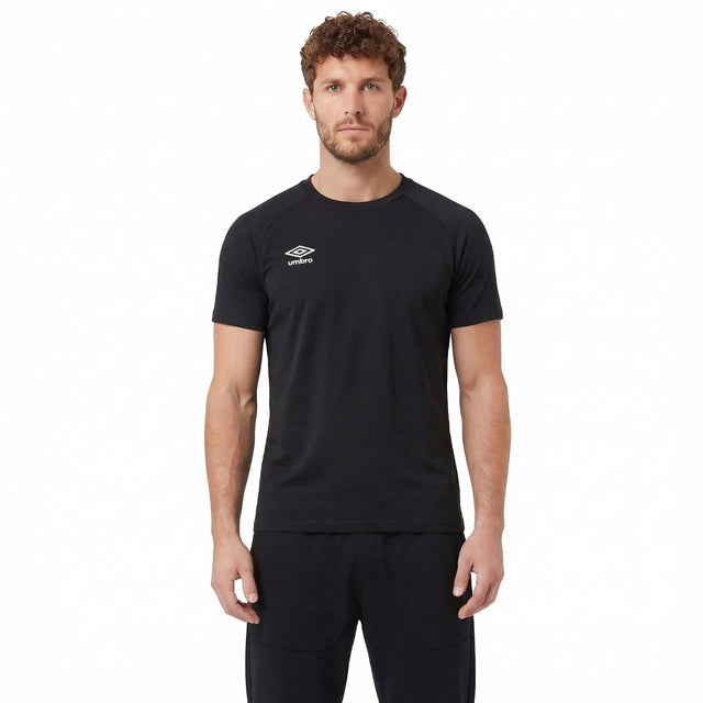 Man wearing a black Umbro t-shirt on a white background