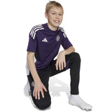 adidas Manchester United Football 2025/26 Kids Short Sleeved Training Jersey Model Kneeling Side Front View