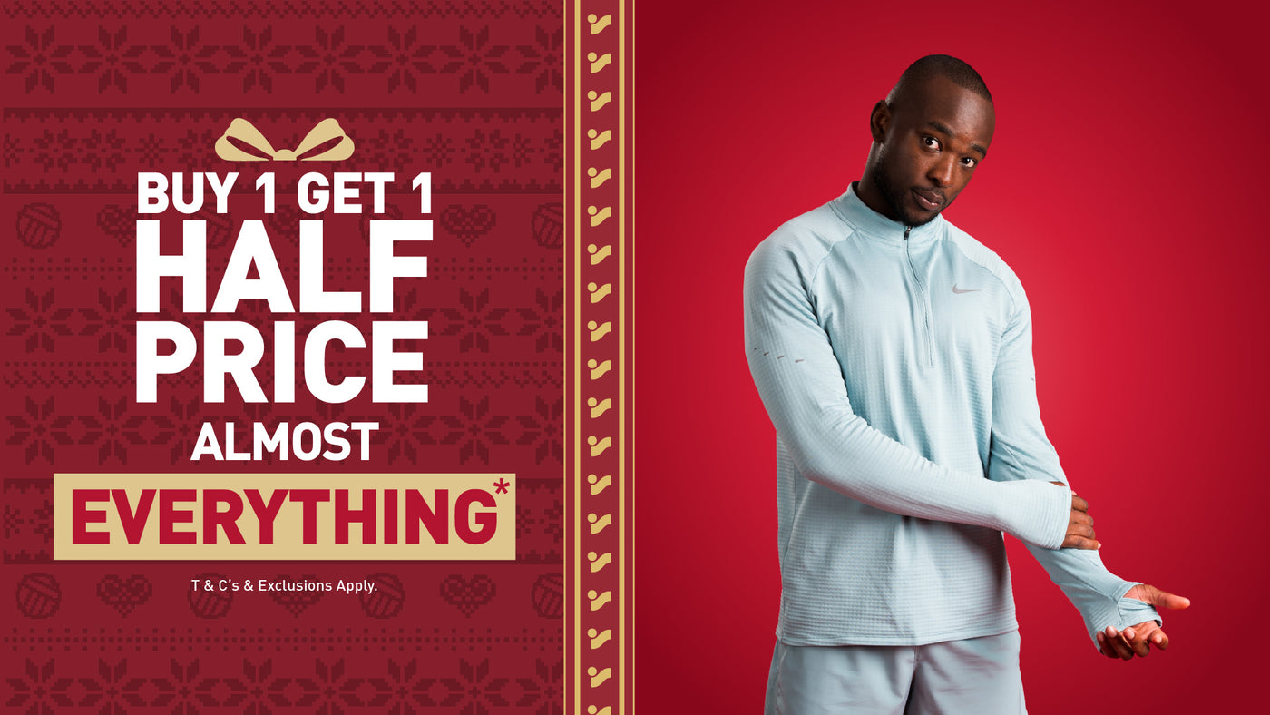 An image of the Intersport Elverys Christmas Black Friday sale offer, calling out Buy 1 Get 1 Half Price on almost everything. Features a man showcasing products as part of the promotion.