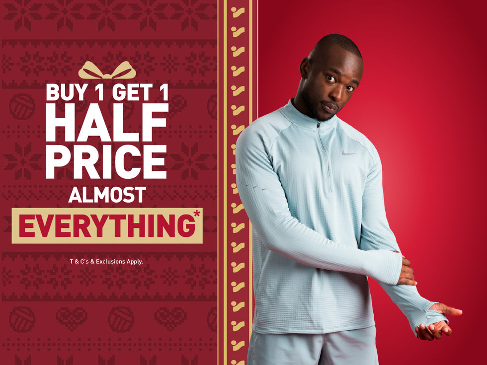 An image of the Intersport Elverys Christmas Black Friday sale offer, calling out Buy 1 Get 1 Half Price on almost everything. Features a man showcasing products as part of the promotion.