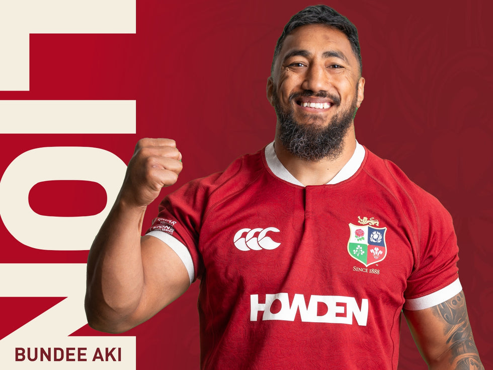 An image of Bundee Aki holding his arm in the air whilst wearing the 2025 British Irish Lions Jersey